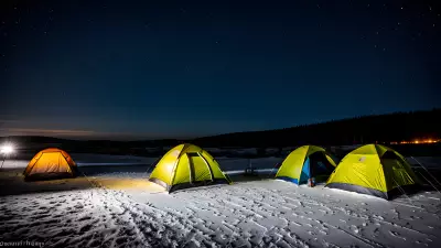 Frozen tents under a tear stained sky